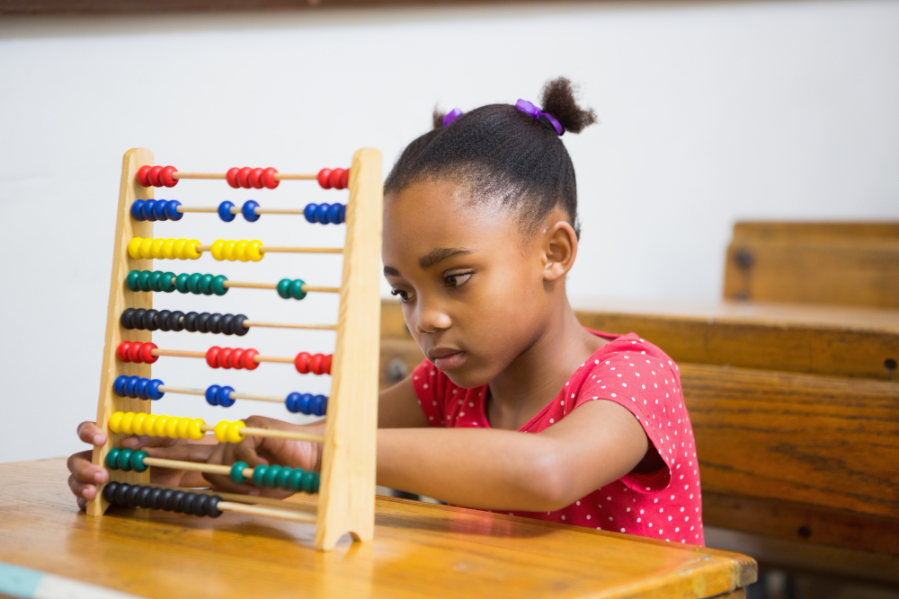 cute-pupil-using-abacus-in-classroom.jpg
