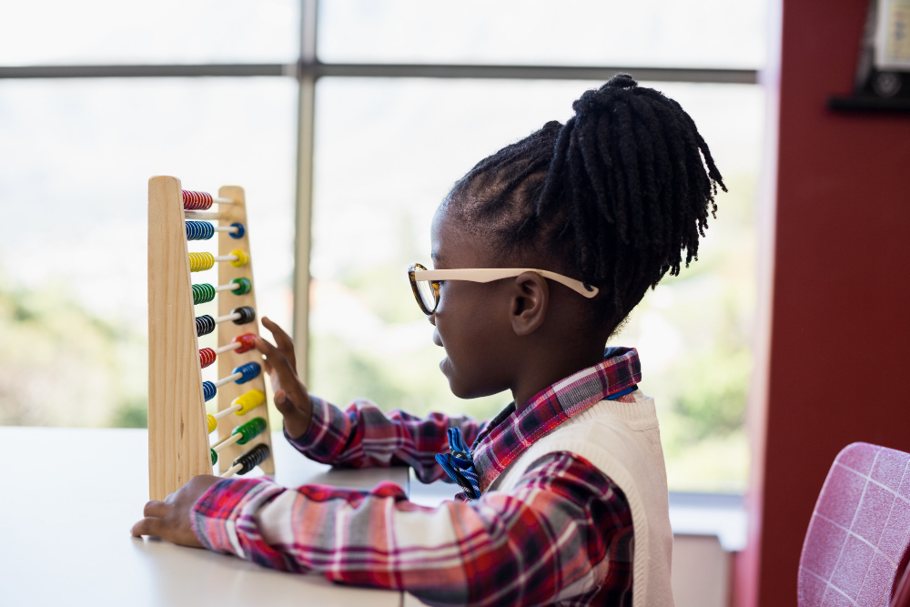 schoolgirl-using-maths-abacus-in-classroom.jpg